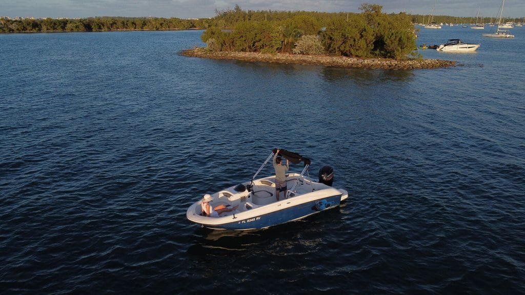 Aerial view of the Bayliner E18 Blue on calm Biscayne Bay water