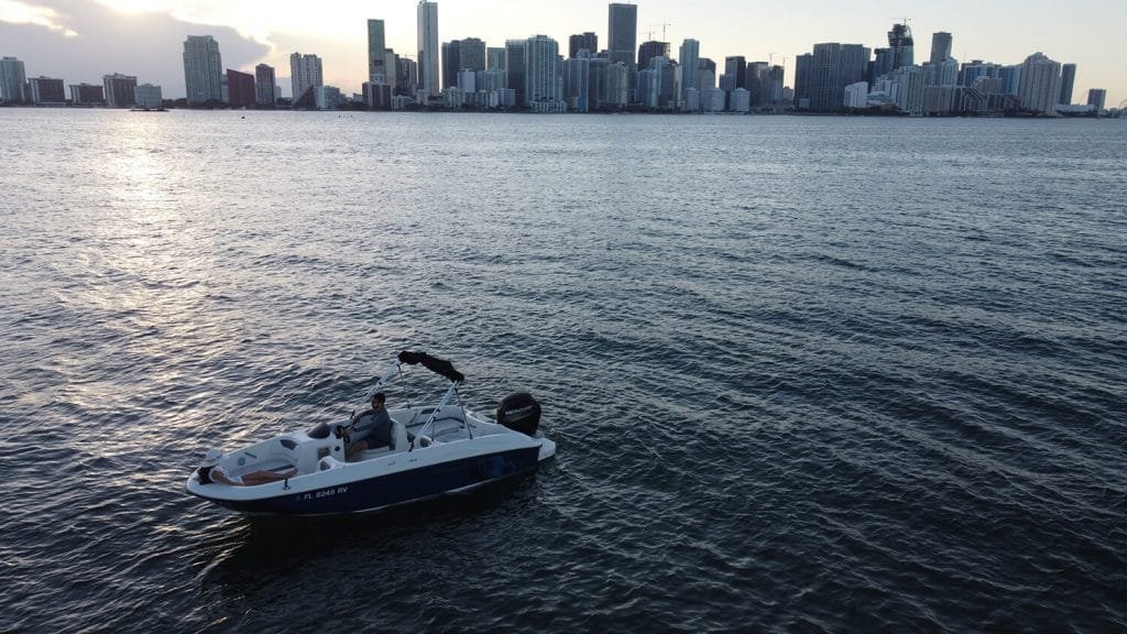 Bayliner E18 Blue with the downtown Miami skyline behind