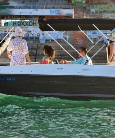 Friends relaxing on a rented Bayliner E18 in Miami